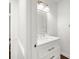 Bathroom featuring a vanity with white marble countertop and ample lighting at 2441 Mitchell Ne Rd, Marietta, GA 30062