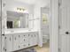 Bathroom featuring a double sink vanity, a large mirror, a separate toilet room, and neutral colors at 2441 Mitchell Ne Rd, Marietta, GA 30062