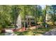 Inviting home with a screened in porch, two car garage, lush lawn, and mature trees at 2441 Mitchell Ne Rd, Marietta, GA 30062