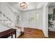 Bright foyer featuring hardwood floors, elegant staircase, and natural light, leading to other rooms at 2441 Mitchell Ne Rd, Marietta, GA 30062