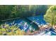 Well-maintained community tennis courts surrounded by mature trees, with convenient access to the pool, promoting an active lifestyle at 2441 Mitchell Ne Rd, Marietta, GA 30062