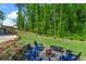 Spacious backyard with mature trees, stone firepit, and seating area at 3603 Allpoint Dr, Marietta, GA 30062