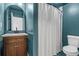 Cozy blue bathroom with wood vanity, marble countertop, shower and toilet at 3603 Allpoint Dr, Marietta, GA 30062