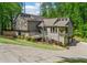 Stunning home features a multi-level deck, mature trees, and lush landscaping creating a private outdoor retreat at 3603 Allpoint Dr, Marietta, GA 30062