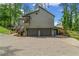 Side view of the home with two-car garage, a cantilevered sunroom and a lush lawn at 3603 Allpoint Dr, Marietta, GA 30062