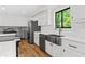 Bright kitchen with stainless steel appliances, a farmhouse sink, white subway tile, and wood flooring at 3603 Allpoint Dr, Marietta, GA 30062