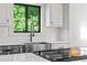 Kitchen with stainless steel sink, black faucet, and a white backsplash at 3603 Allpoint Dr, Marietta, GA 30062