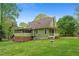 Exterior showcasing the home's screened porch and large backyard, perfect for outdoor enjoyment at 503 Pinehurst Ln, Woodstock, GA 30188