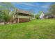 Green backyard view featuring a deck, screened porch, and lush lawn at 503 Pinehurst Ln, Woodstock, GA 30188