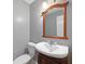 Bathroom with wood-framed mirror and white vessel sink at 503 Pinehurst Ln, Woodstock, GA 30188