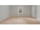 A bright bedroom has neutral walls and plush carpeting at 503 Pinehurst Ln, Woodstock, GA 30188