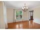 Bright dining room featuring hardwood floors, large windows, and elegant lighting at 503 Pinehurst Ln, Woodstock, GA 30188