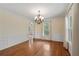 Elegant dining room with hardwood floors, chandelier, and ample natural light at 503 Pinehurst Ln, Woodstock, GA 30188