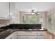 A kitchen view showcasing an electric cooktop, granite countertops, and a windowed dining nook at 503 Pinehurst Ln, Woodstock, GA 30188