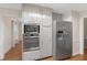A full kitchen with stainless refrigerator and built-in microwave and oven at 503 Pinehurst Ln, Woodstock, GA 30188