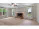 Large living room featuring a brick fireplace, neutral carpet and many windows at 503 Pinehurst Ln, Woodstock, GA 30188