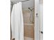 A tiled shower stall features bronze fixtures and neutral accents at 503 Pinehurst Ln, Woodstock, GA 30188