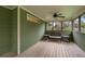 Inviting sunroom with wood floors, wicker seating, and peaceful backyard views at 503 Pinehurst Ln, Woodstock, GA 30188
