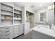 Modern bathroom featuring a walk-in shower, white marble-style wall tiles, and ample cabinet space at 1153 Chatsworth Dr, Avondale Estates, GA 30002