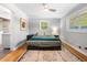 Serene bedroom with hardwood floors and neutral paint, located next to a modern designed bathroom at 1153 Chatsworth Dr, Avondale Estates, GA 30002