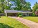 Lovely one-story brick house showcasing a long driveway and a well-maintained lawn at 1153 Chatsworth Dr, Avondale Estates, GA 30002