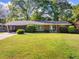 Charming brick home with a well-manicured lawn and a covered parking area, perfect for a Gathering at 1153 Chatsworth Dr, Avondale Estates, GA 30002