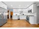 Modern kitchen with stainless steel appliances, white cabinetry, and hardwood floors at 1153 Chatsworth Dr, Avondale Estates, GA 30002