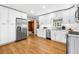 Bright, newly renovated kitchen with white cabinetry, stainless steel appliances and hardwood floors at 1153 Chatsworth Dr, Avondale Estates, GA 30002