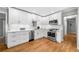 Beautiful modern kitchen with stainless steel appliances, white cabinets, and hardwood floors at 1153 Chatsworth Dr, Avondale Estates, GA 30002