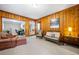 Cozy living room with wood paneling, neutral carpet, and ample seating, creating an inviting atmosphere at 1153 Chatsworth Dr, Avondale Estates, GA 30002
