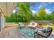 Inviting patio with outdoor seating and a view of the lush, landscaped backyard at 1153 Chatsworth Dr, Avondale Estates, GA 30002