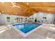 Spacious indoor pool with vaulted ceilings, recessed lights, multiple windows, and poolside seating at 1153 Chatsworth Dr, Avondale Estates, GA 30002