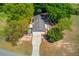 Aerial view of a lovely home with a long driveway and a detached garage surrounded by mature trees at 1312 Harbins Rd, Dacula, GA 30019