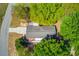 Aerial view of a well-maintained property featuring lush trees and a long driveway at 1312 Harbins Rd, Dacula, GA 30019