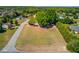 An aerial view of a vacant lot in a wooded residential neighborhood, on a corner lot at 1312 Harbins Rd, Dacula, GA 30019