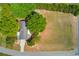 Aerial view of a property featuring a long driveway and a large grassy yard at 1312 Harbins Rd, Dacula, GA 30019
