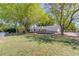 Aerial view showcases the expansive backyard with a deck, shed, and mature trees at 1312 Harbins Rd, Dacula, GA 30019