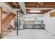 Unfinished basement featuring stairs, HVAC equipment, and workbench area with shelving at 1312 Harbins Rd, Dacula, GA 30019
