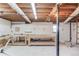 Spacious unfinished basement featuring concrete floors, ductwork and several work benches at 1312 Harbins Rd, Dacula, GA 30019
