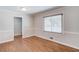Bedroom with hardwood floors, neutral walls, white trim and a window for natural light at 1312 Harbins Rd, Dacula, GA 30019