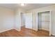 Bright bedroom features hardwood floors, neutral paint, closet and doorway to additional rooms at 1312 Harbins Rd, Dacula, GA 30019