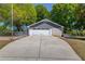 Image of a detached garage with gray trim and a long driveway, offering ample parking and storage at 1312 Harbins Rd, Dacula, GA 30019