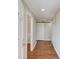 Hallway with hardwood floors, white walls, and white trim leading to the rest of the home at 1312 Harbins Rd, Dacula, GA 30019