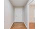 Hallway with hardwood floors and white front door at 1312 Harbins Rd, Dacula, GA 30019
