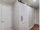 Bright hallway featuring a modern sliding barn door at 1312 Harbins Rd, Dacula, GA 30019