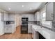 A newly renovated kitchen featuring stainless steel appliances, a farmhouse sink, and stylish cabinets at 1312 Harbins Rd, Dacula, GA 30019
