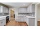 Kitchen featuring gray cabinets, stainless appliances, farm sink and tile backsplash at 1312 Harbins Rd, Dacula, GA 30019