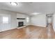 Living room with fireplace, hardwood floors and a sliding barn door at 1312 Harbins Rd, Dacula, GA 30019