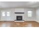 Living room with hardwood floors, fireplace and a window for natural light at 1312 Harbins Rd, Dacula, GA 30019