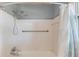 Shower with white tile, grab bar, and shower curtain at 1312 Harbins Rd, Dacula, GA 30019